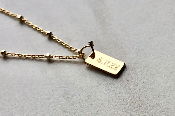 date tag necklace